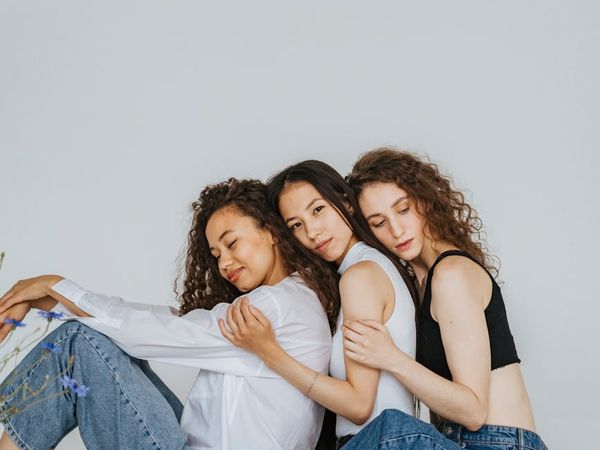 A diverse group of people sitting peacefully in a bright, modern studio.